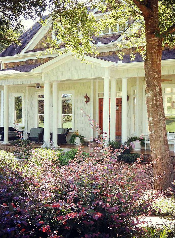 A close up of a flower garden in front of a building