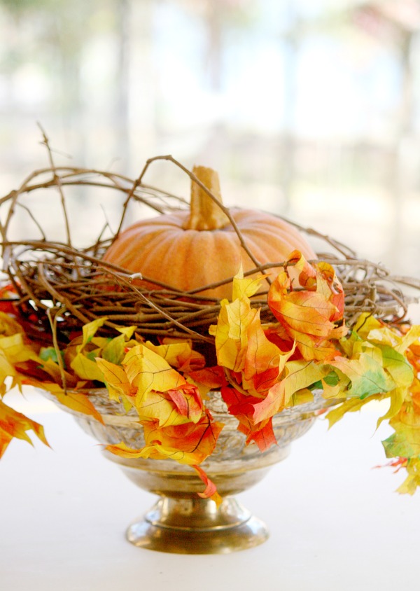 Easy Fall arrangement using a faux pumpkin and dry leaves.