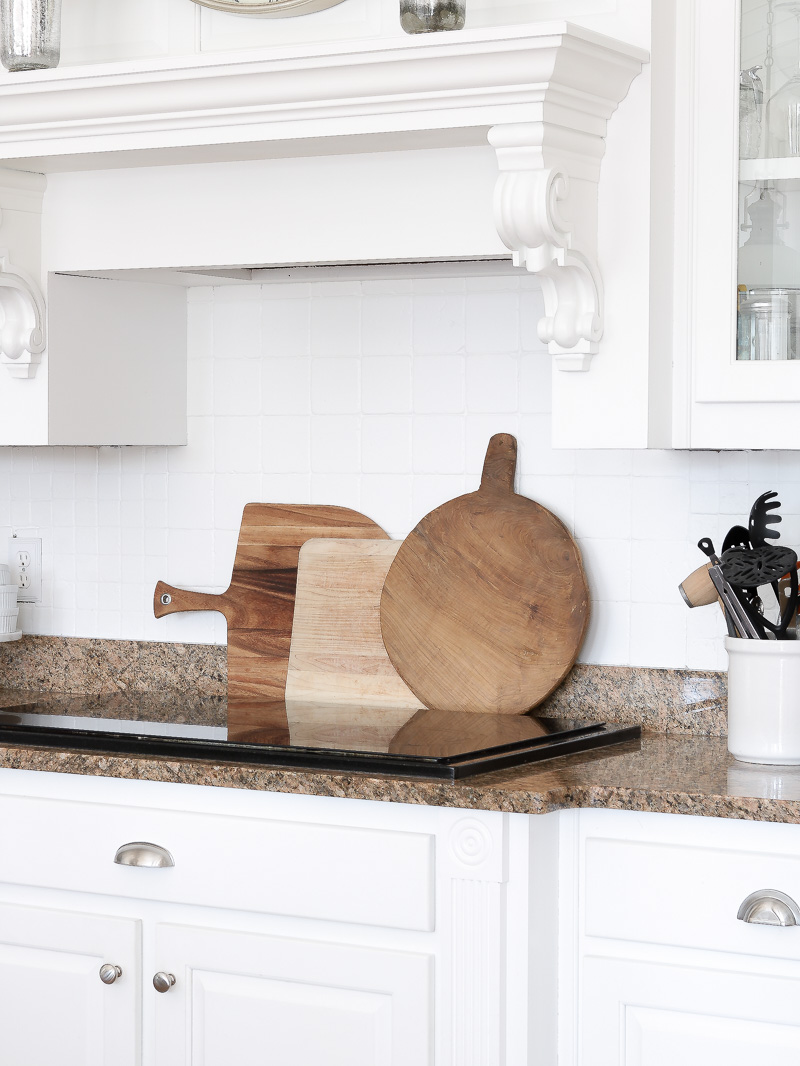 Create warmth in a white kitchen using cutting boards