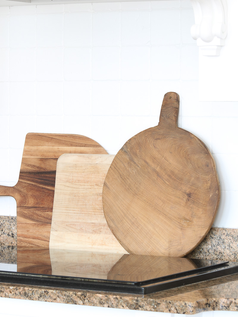 Create warmth in a white kitchen using cutting boards