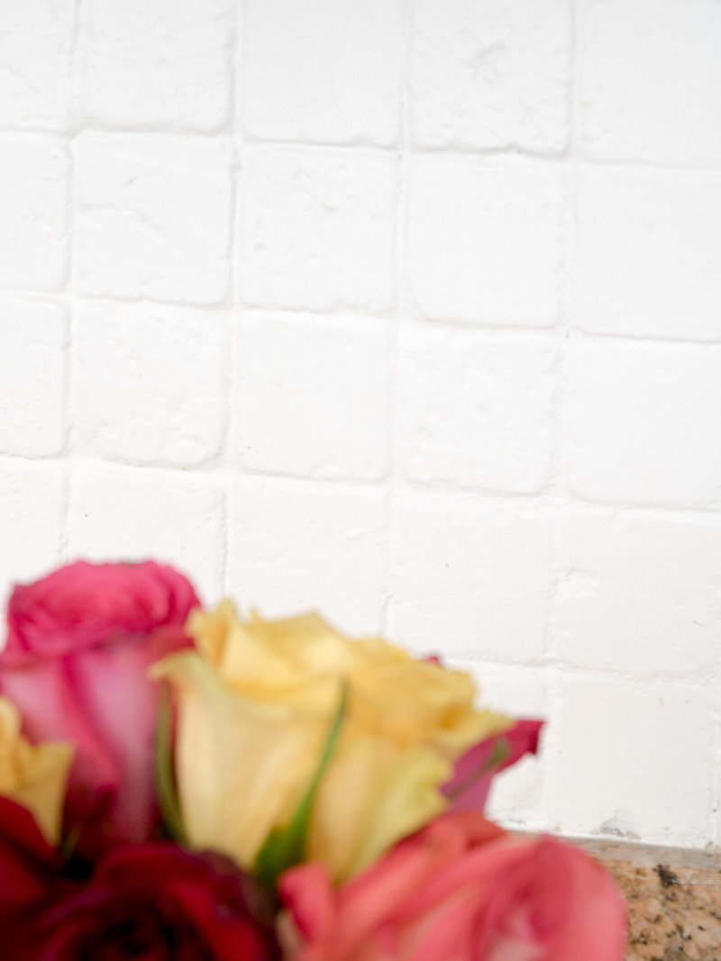 close up of painted tile kitchen backsplash in white