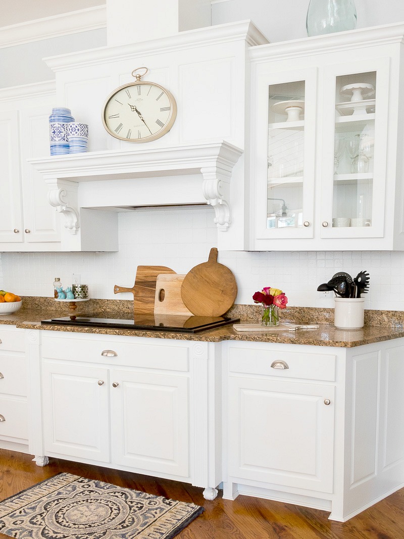 white cabinets with kitchen mantel with leaning cutting boards