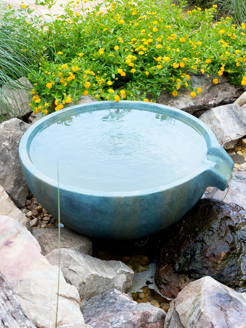 Spillway bowl and basin in a backyard pond