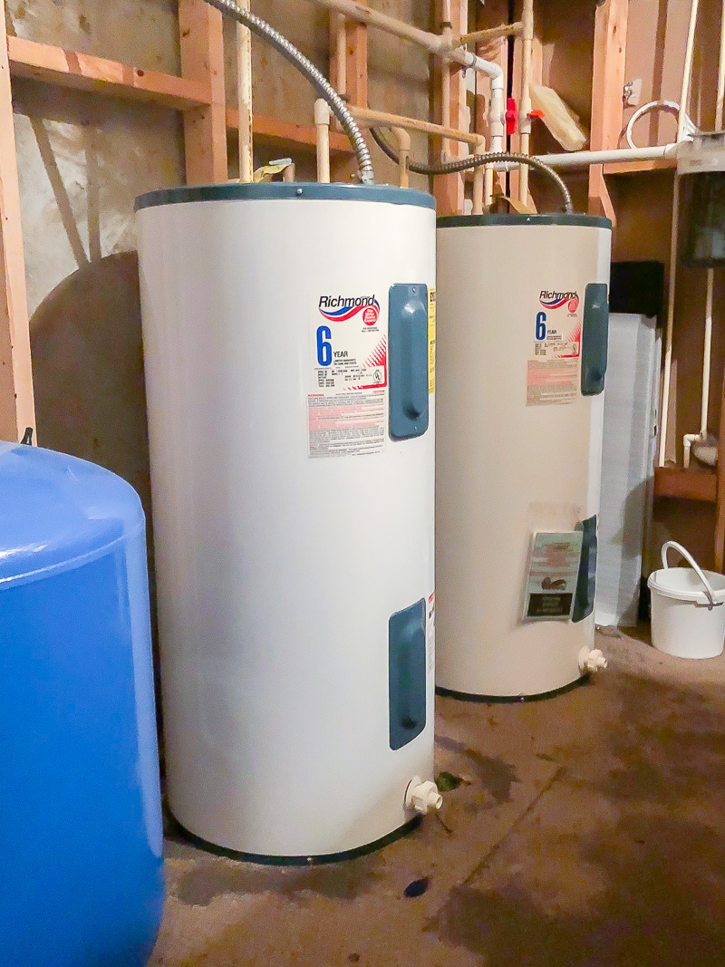 two hot water tanks in a storage room