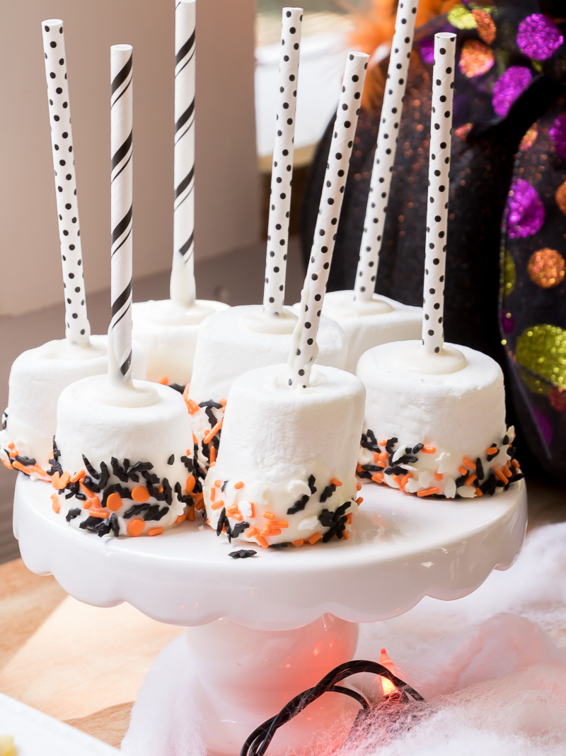 chocolate dipped marshmallows on a white tray.