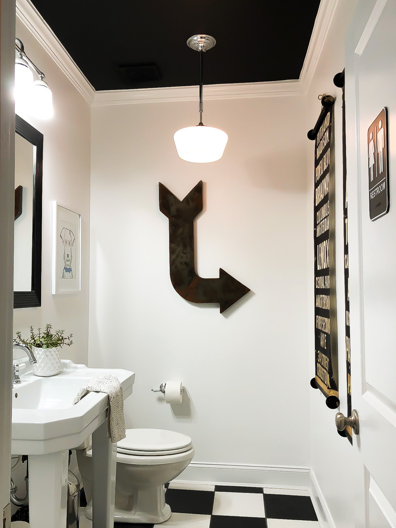 bathroom with white walls and black ceiling