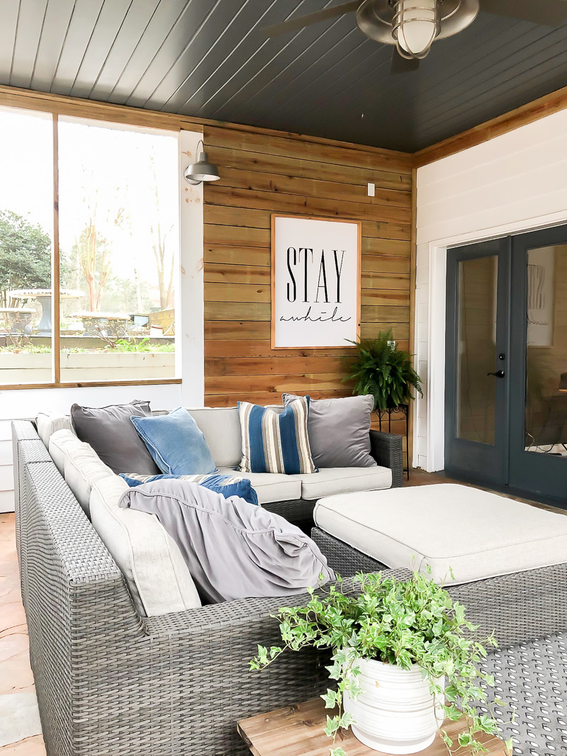 screen porch with wood walls and dark ceiling