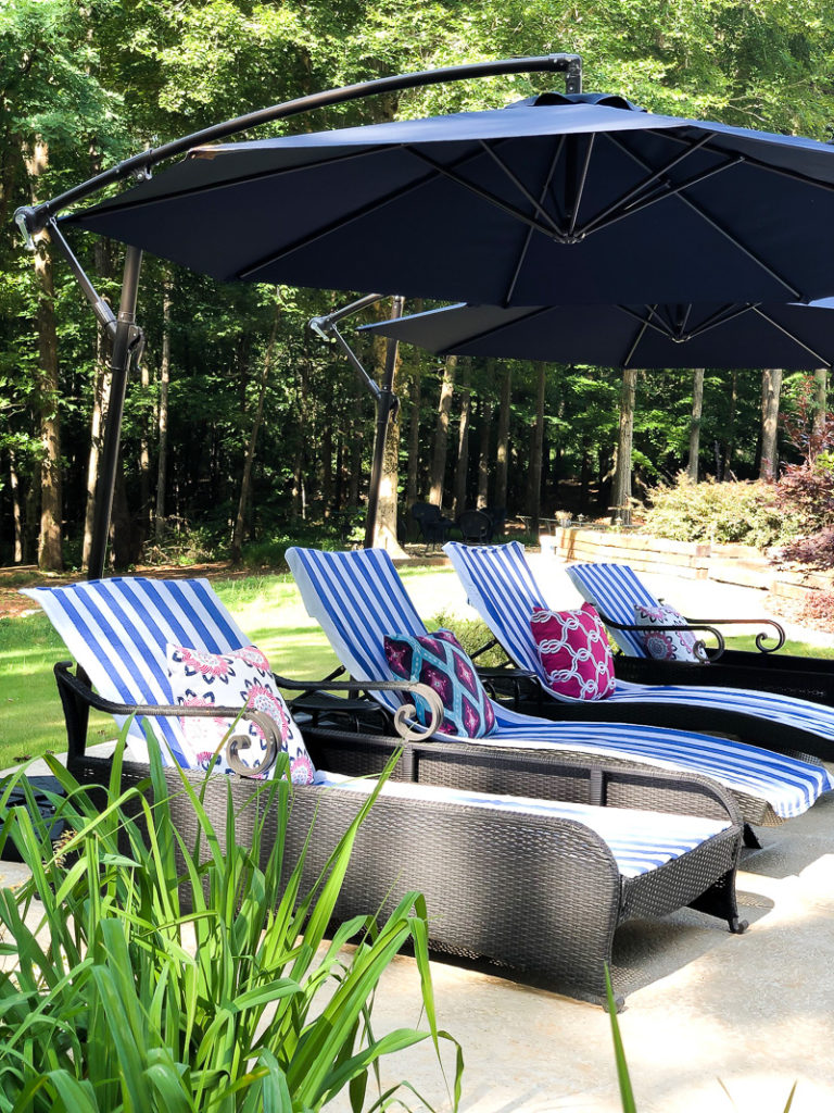 chaise lounges with striped towels and pillows