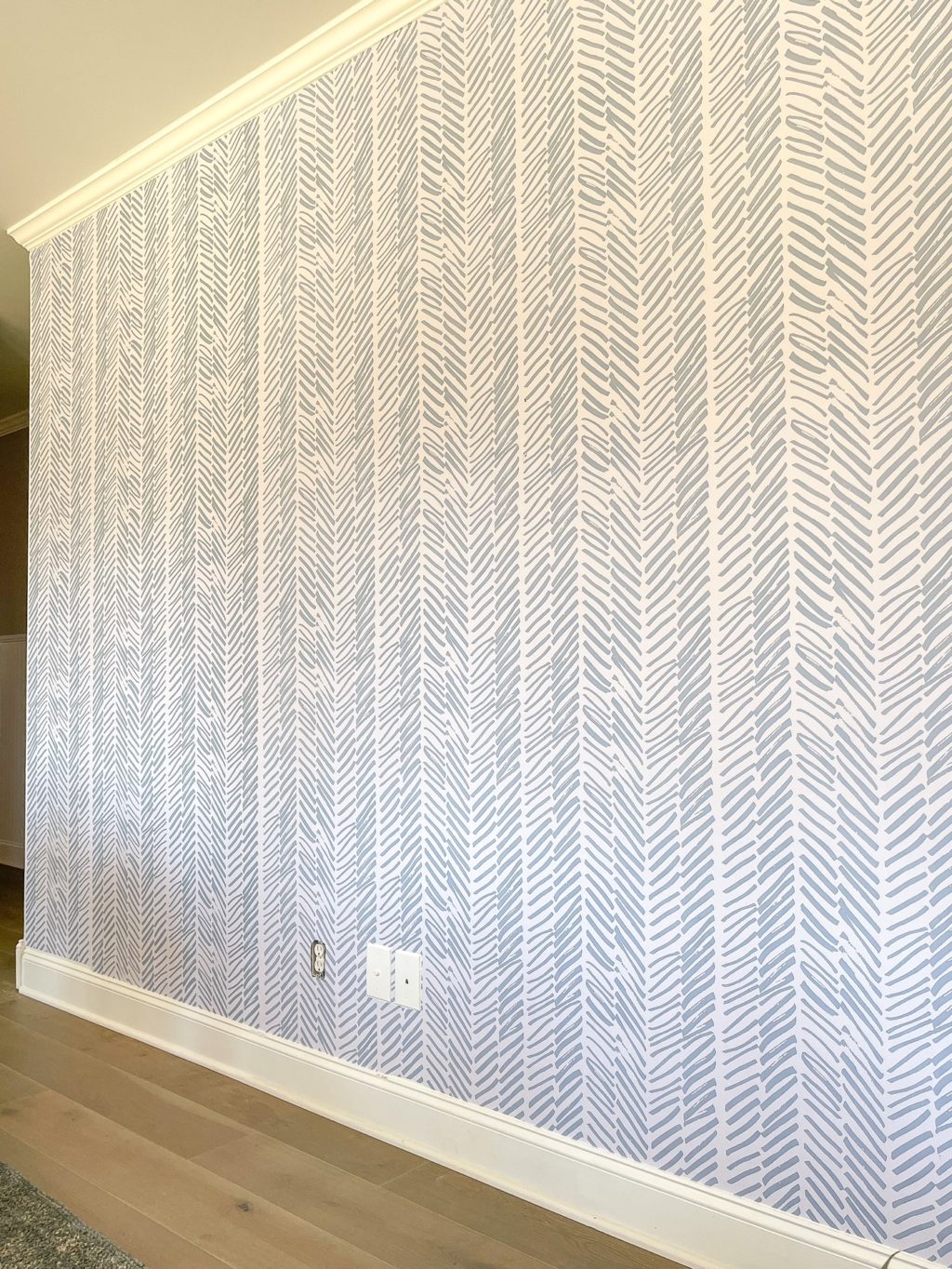 angled view of wall with blue and white wallpaper