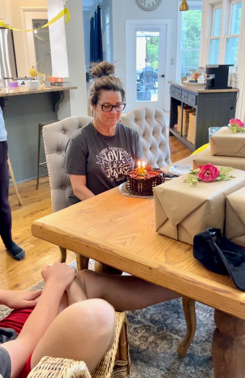 sitting at table with birthday cake