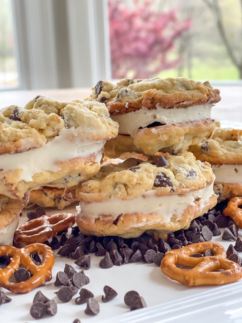 stuffed chocolate chip cookies with frosting on a white plate