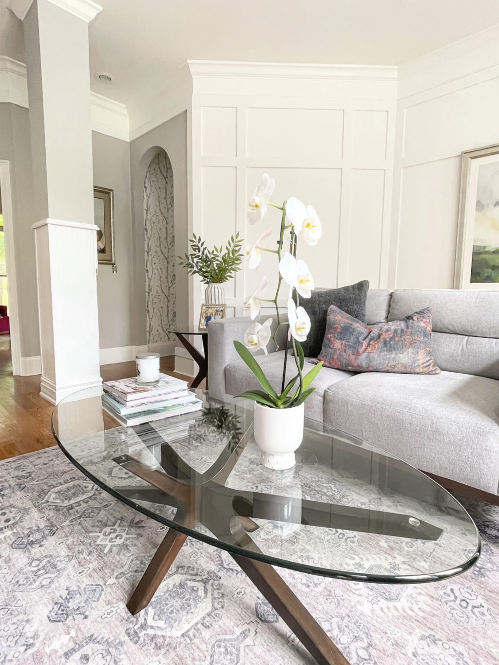 living room, with white orchid on a glass coffee table