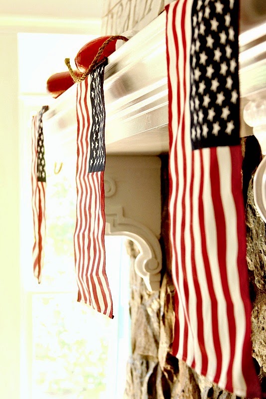small American flags hanging on a mantel