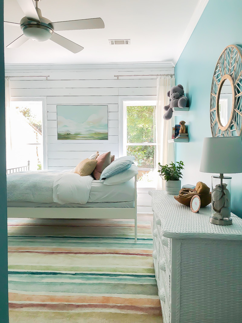 beach inspired bedroom with white wood walls
