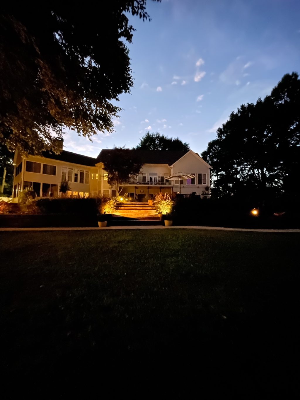 back of house with outdoor lighting