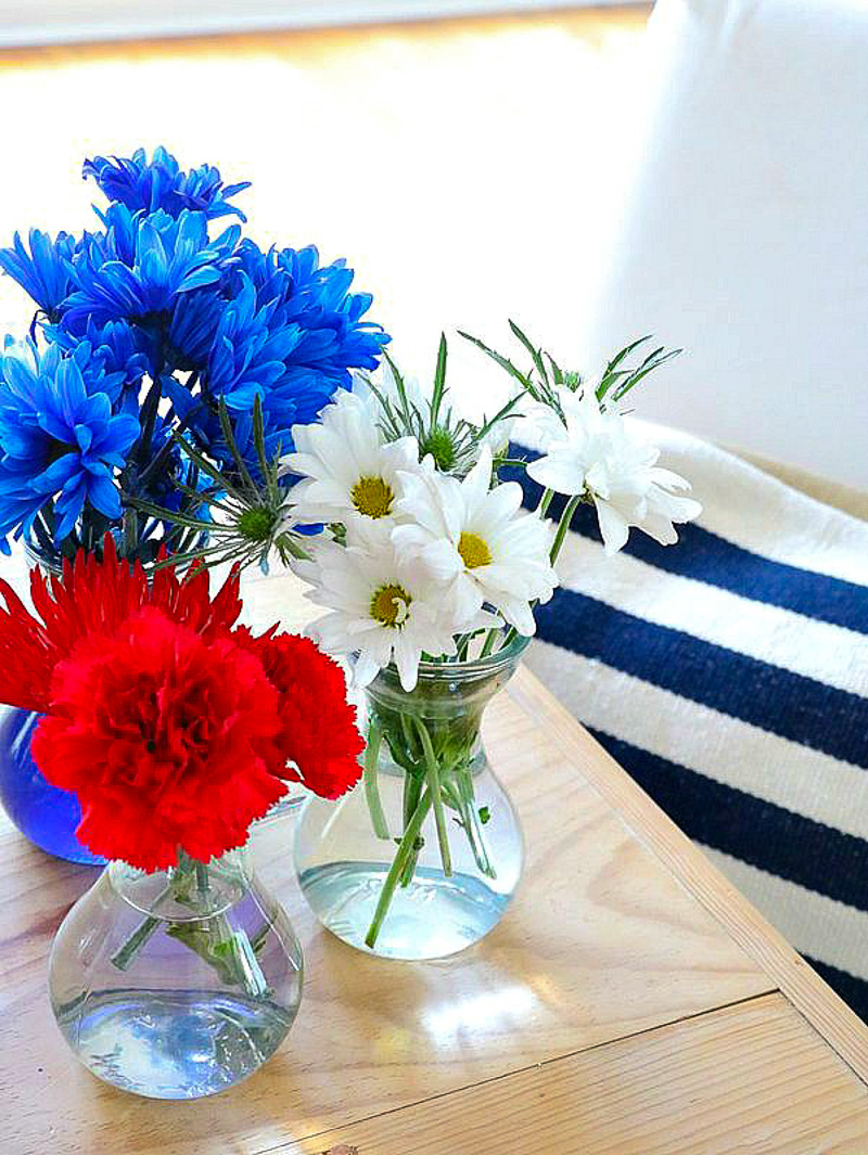 small vases with red, white and blue flowers