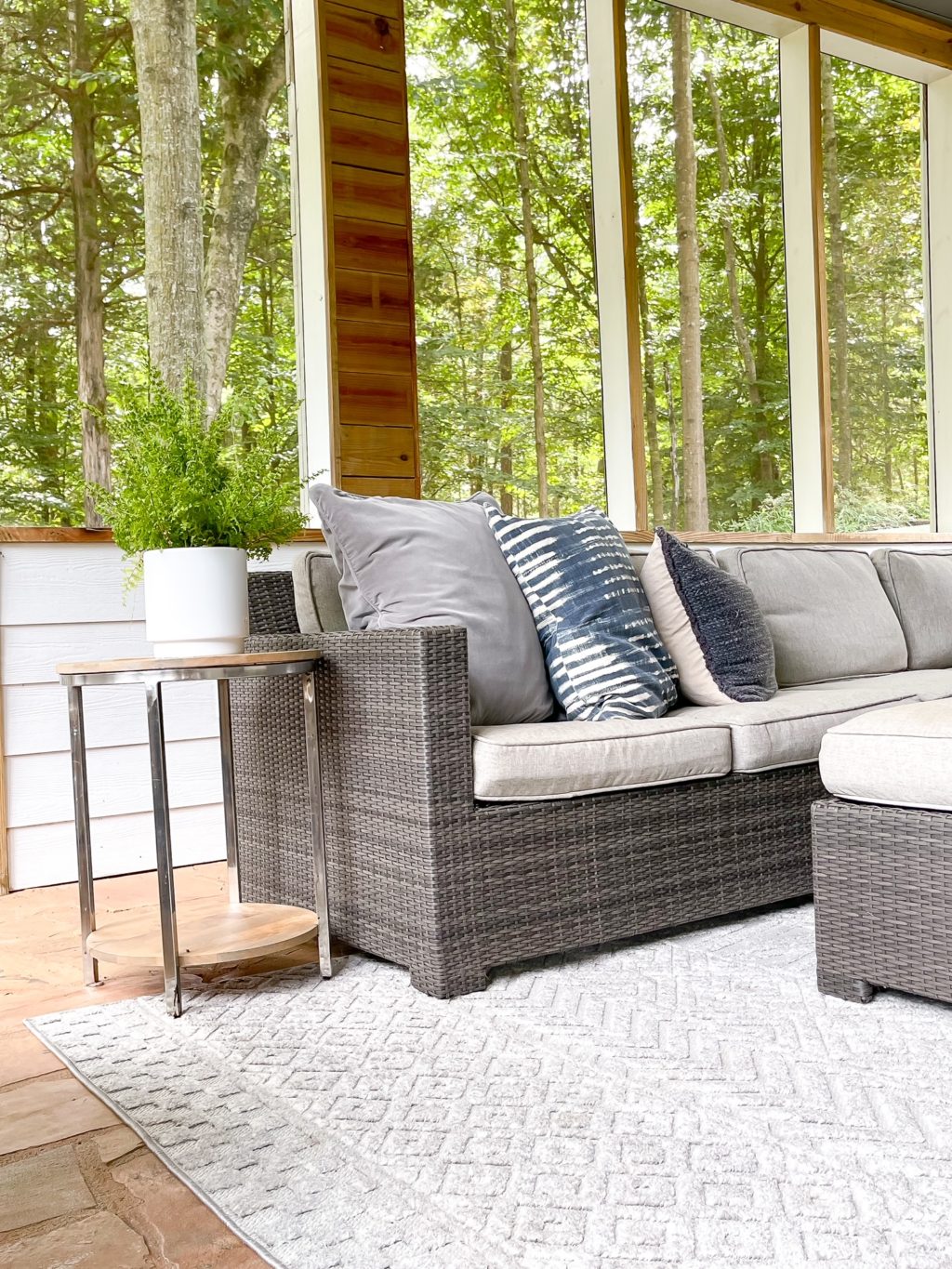 outdoor room with sectional and gray and white rug