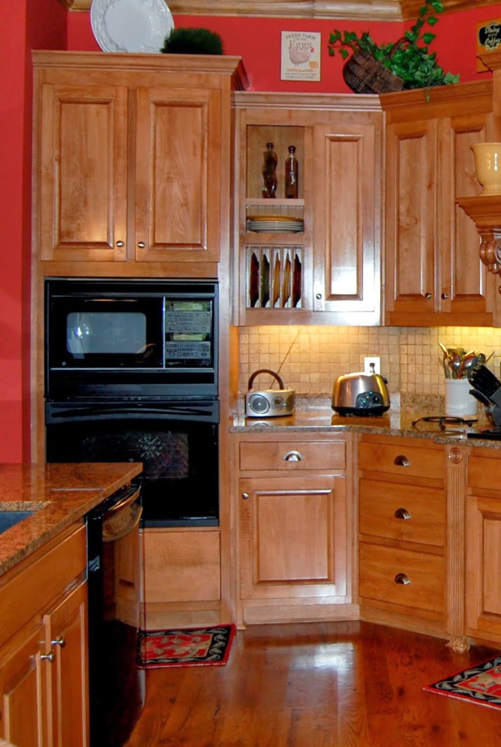 maple wood cabinets and red walls .kitchen from early 2000