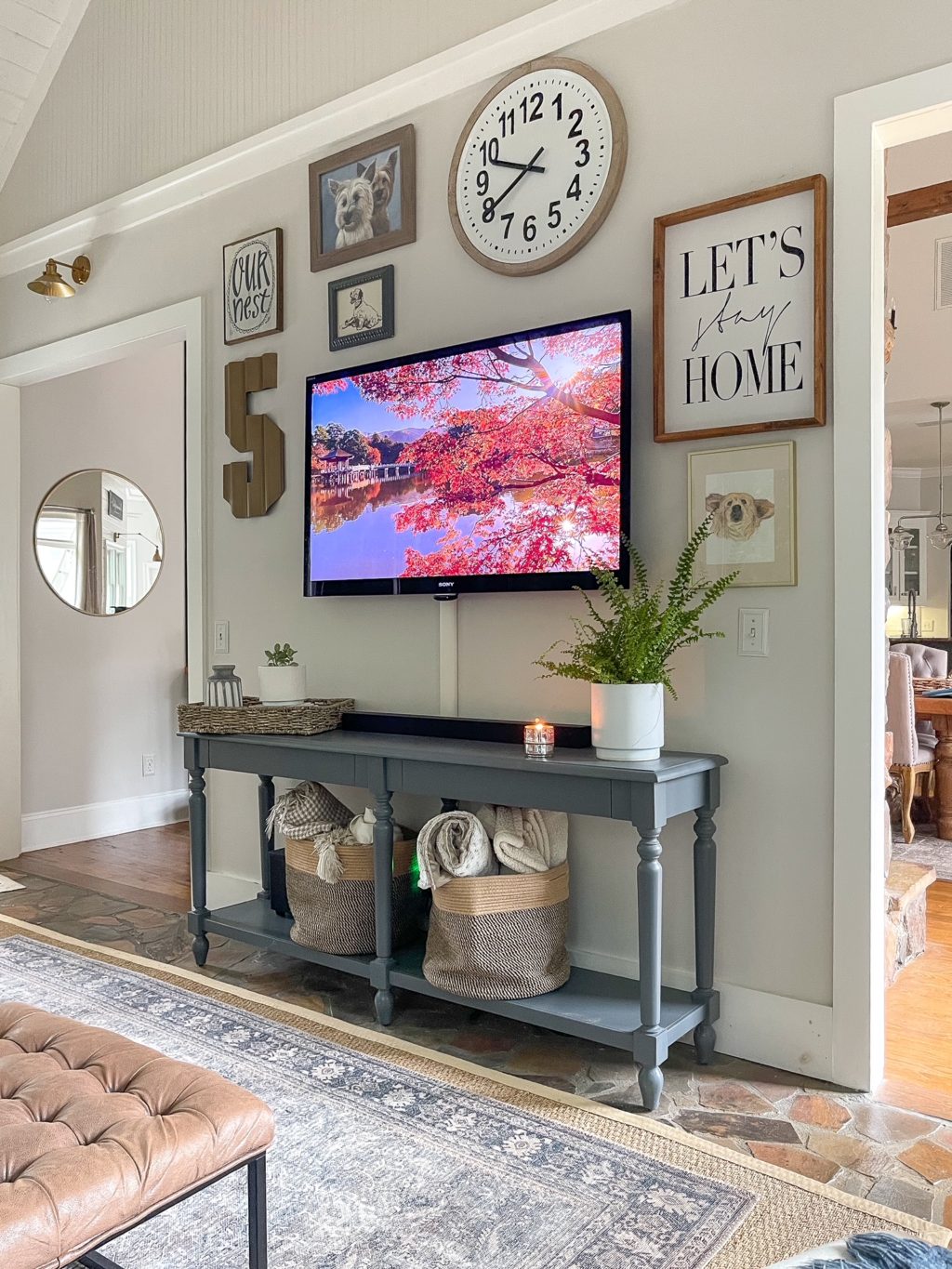 Gray console table with gallery wall behind it.