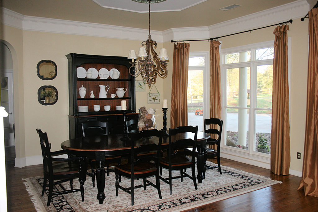 dining room table and chairs with mustard gold curtains