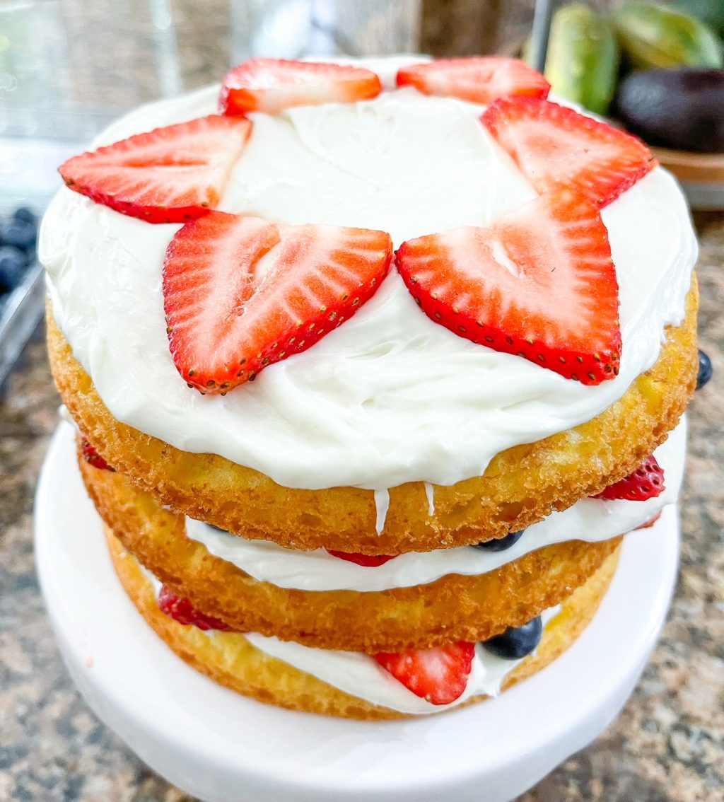 layered cake with strawberry flower on top