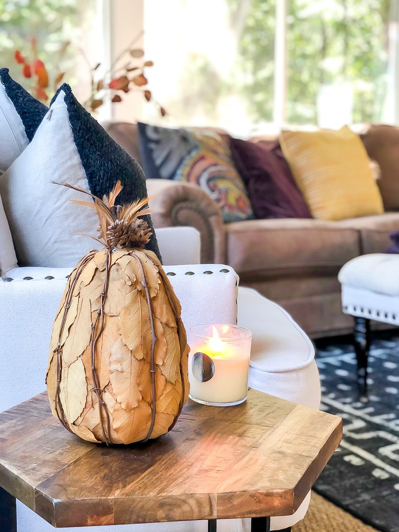 brown leather sectional with autumn color pillows