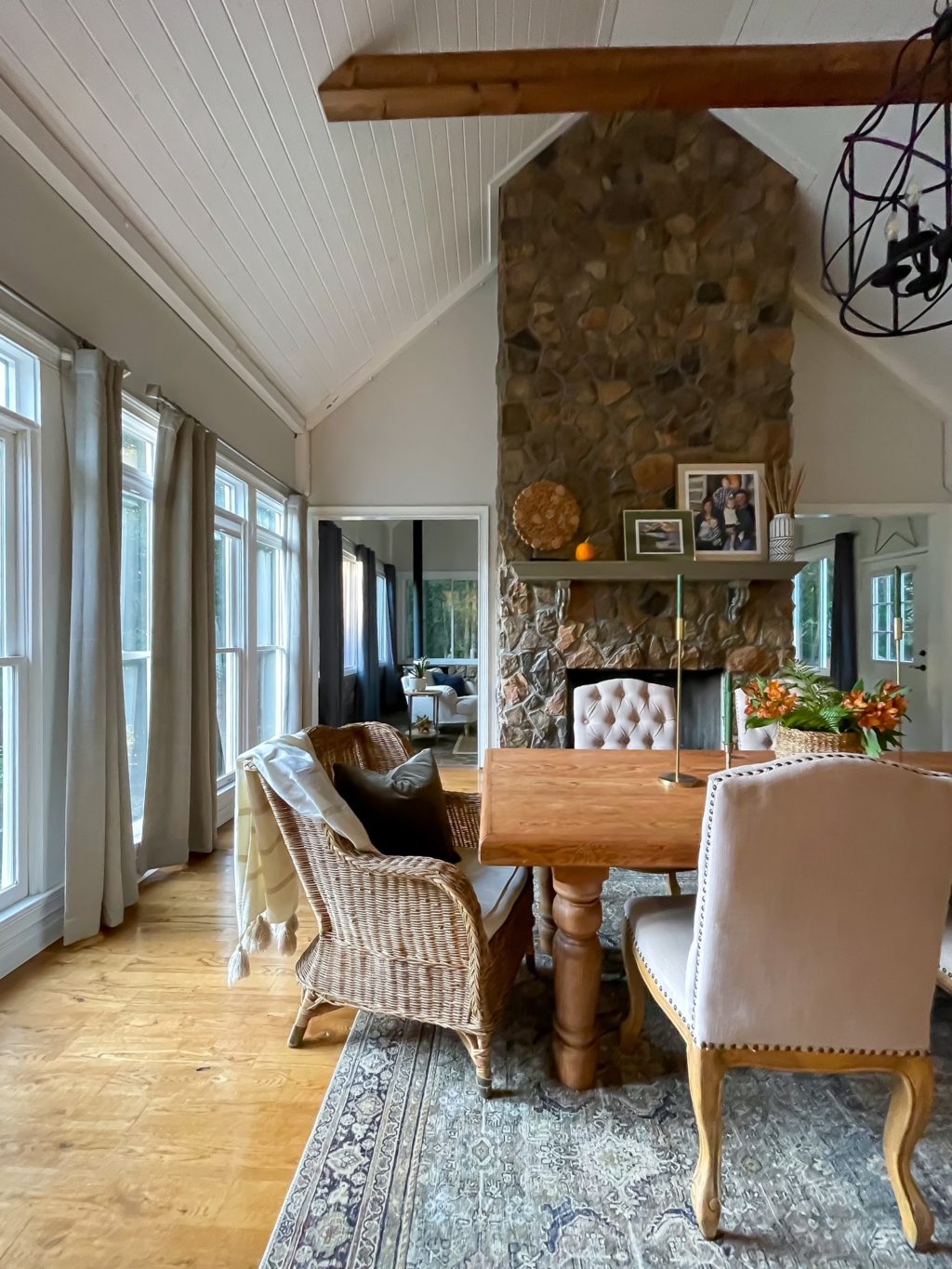 Dining room decorated for fall with floor to ceiling fireplace.