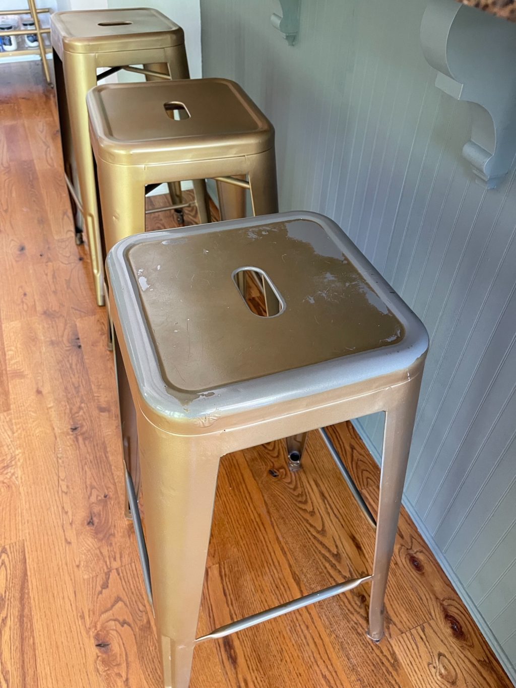 Metal counter stools that need to be refreshed due to chipping paint.