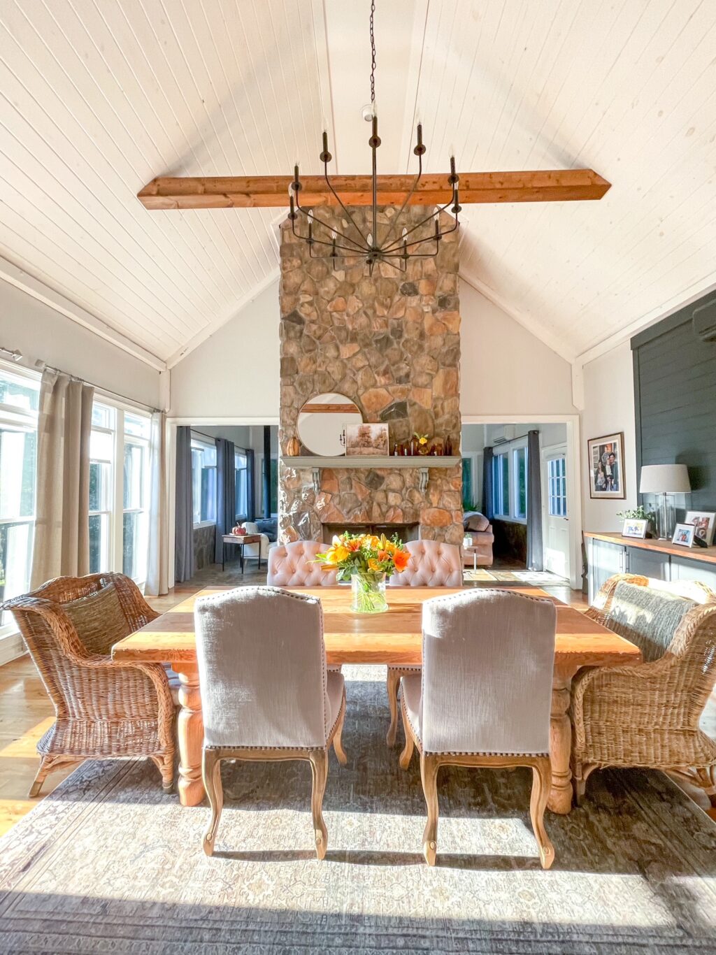 Dining room with floor to ceiling fireplace in the background.