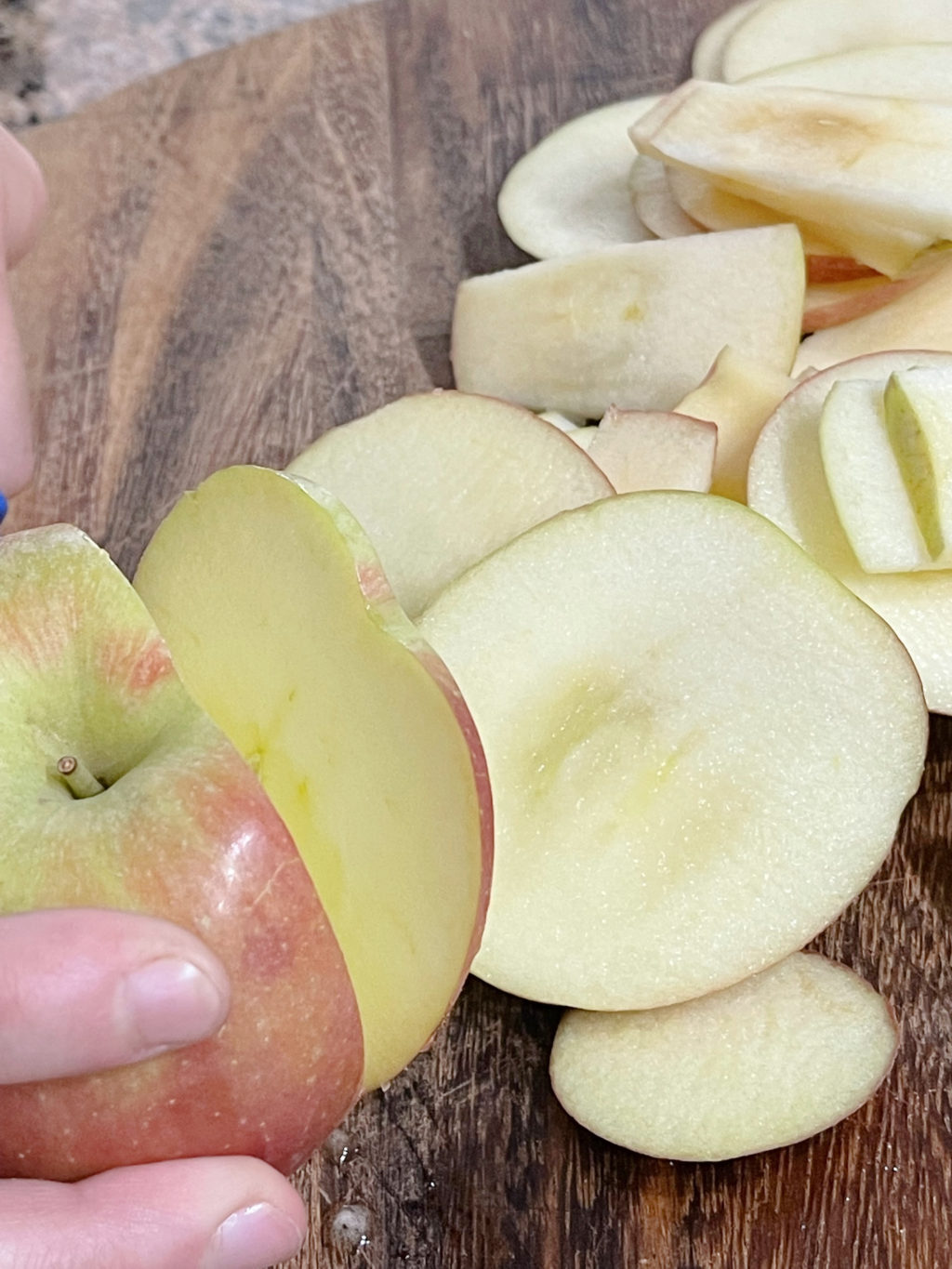 Slicing apples on a cutting board.