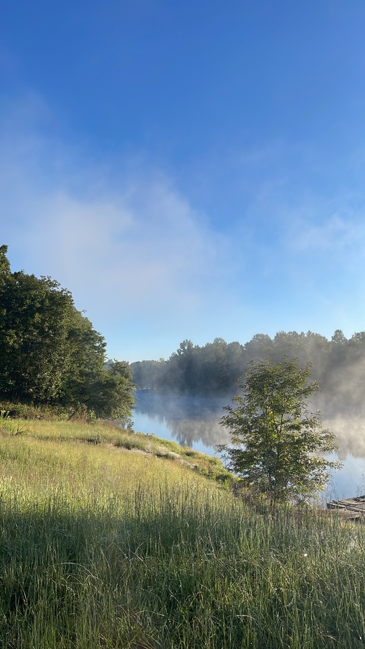 Morning view of lake with fog coming off the water.