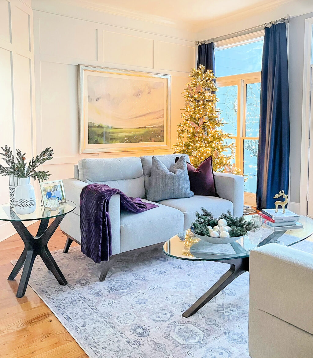 gray sofa with christmas tree in the corner