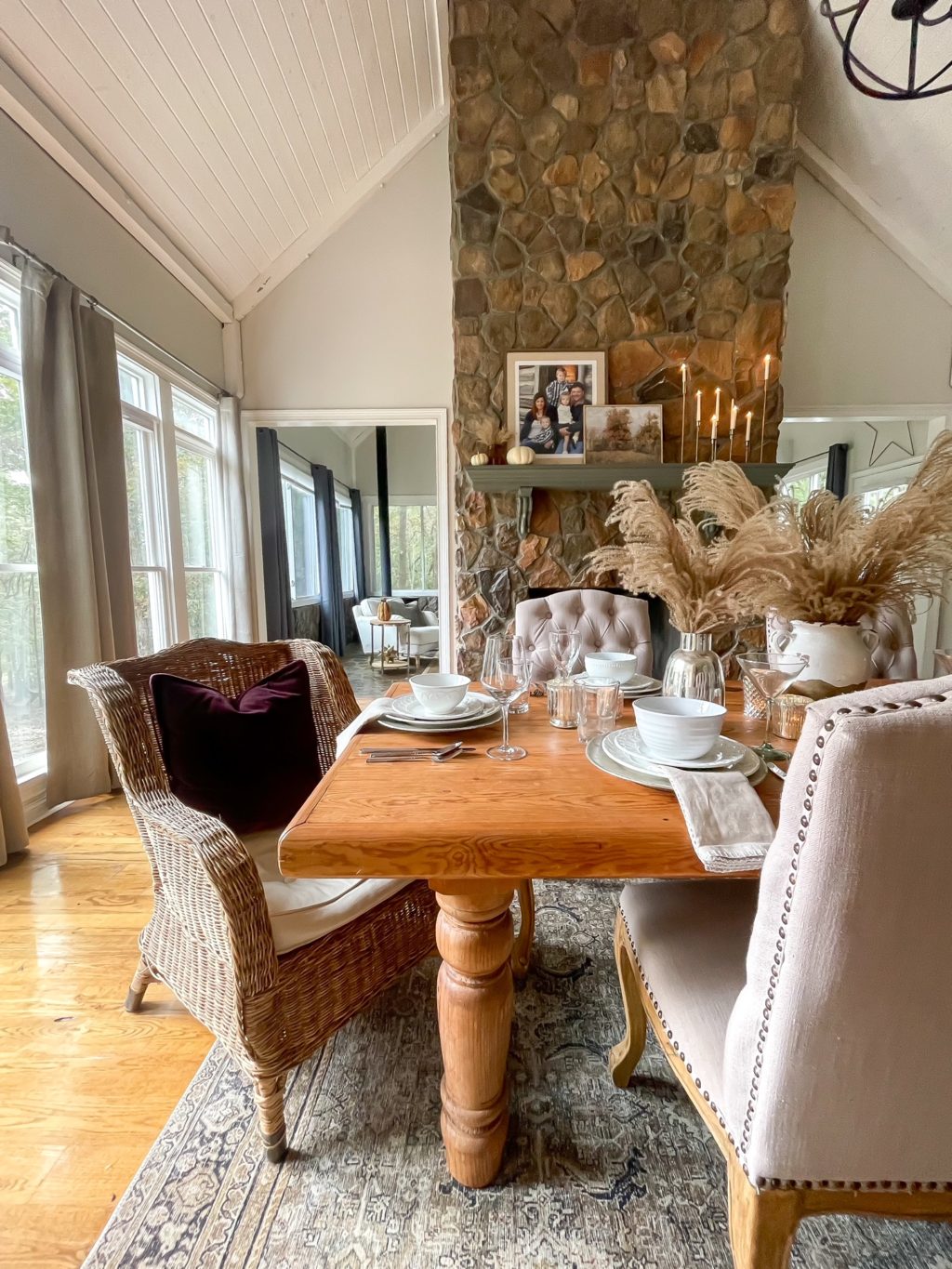 Wood table with white plates and pampas grass