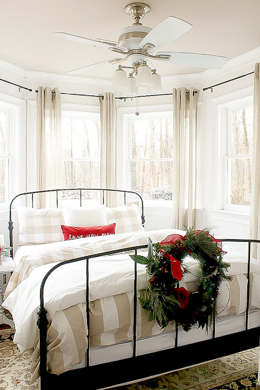 bed with a wreath on footboard