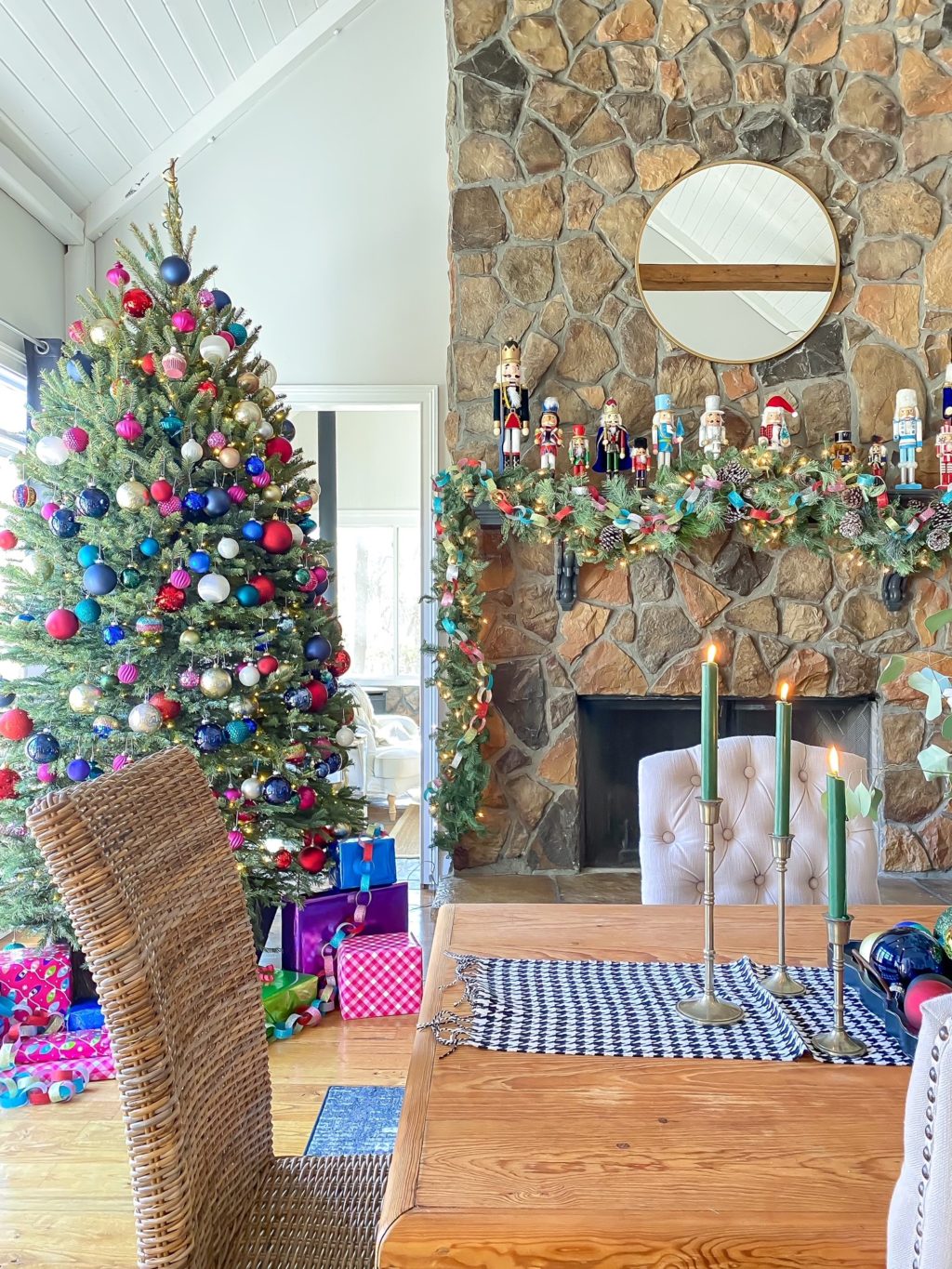 Christmas tree with different colored ornaments and nutcrackers on mantel
