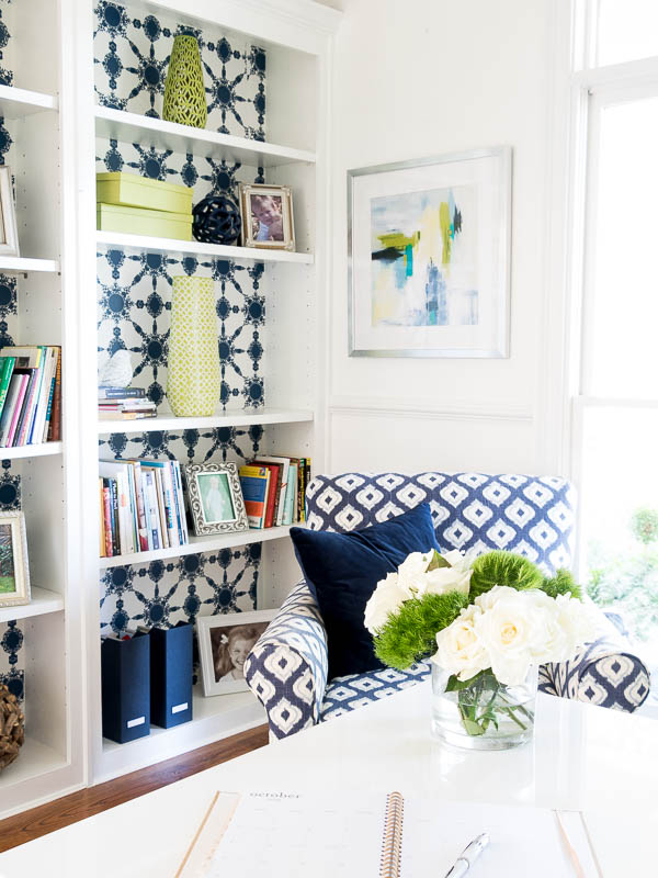 Blue accent chair in the corner of an office.