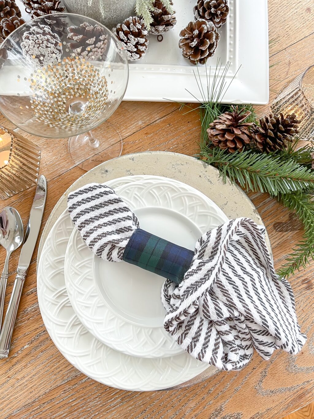 overhead of holiday tablescape with white plates