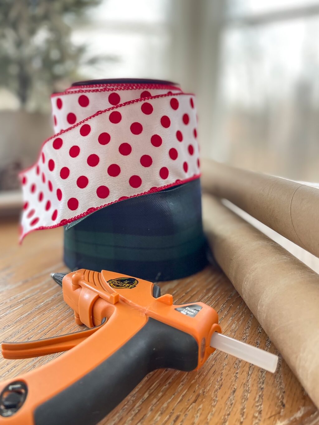 spools of ribbon, cardboard rolls and hot glue gun