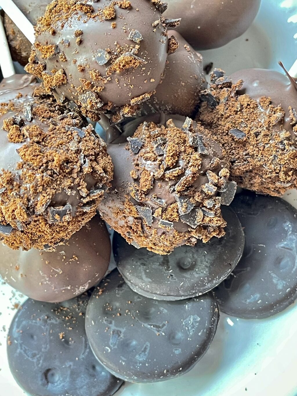 close up on thin mint cookie pops on a white plate