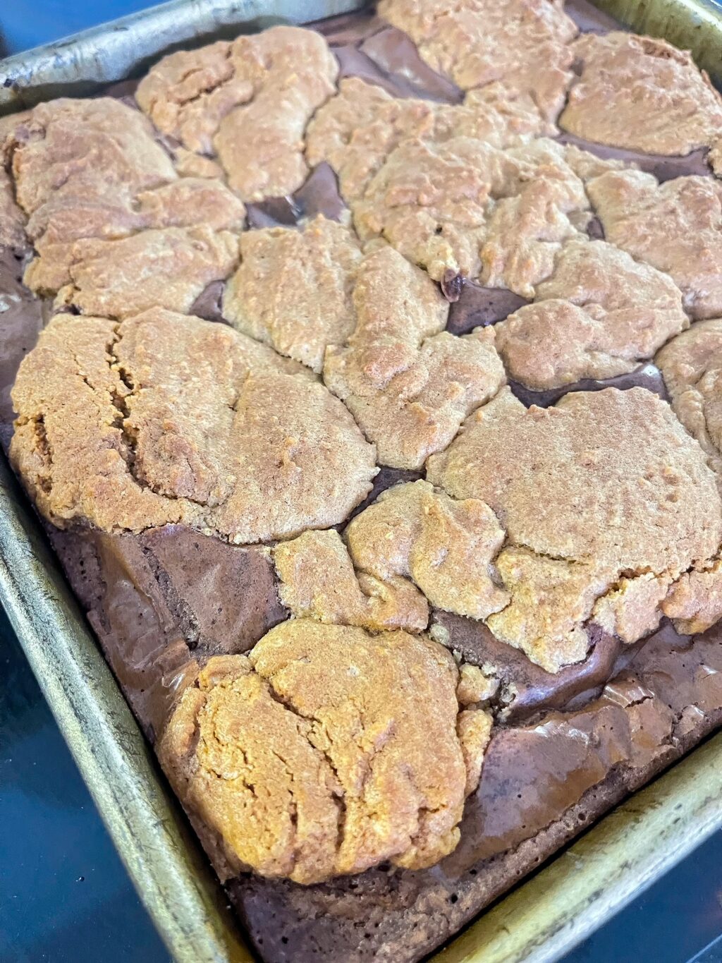cooked cookie on top of brownie