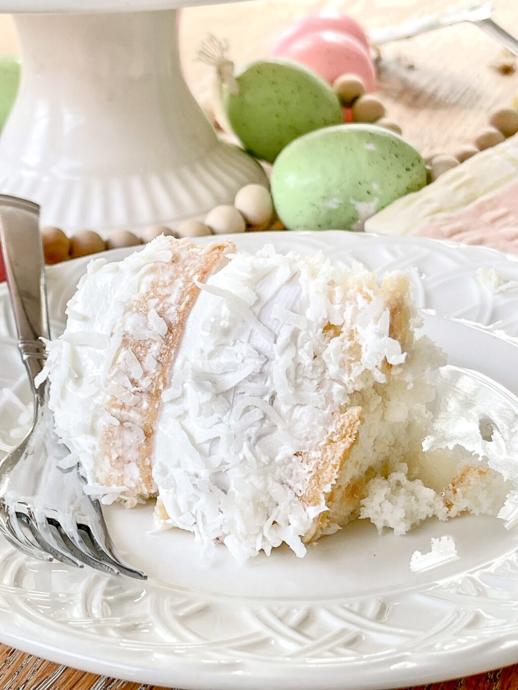 slice of coconut cake on a white plate