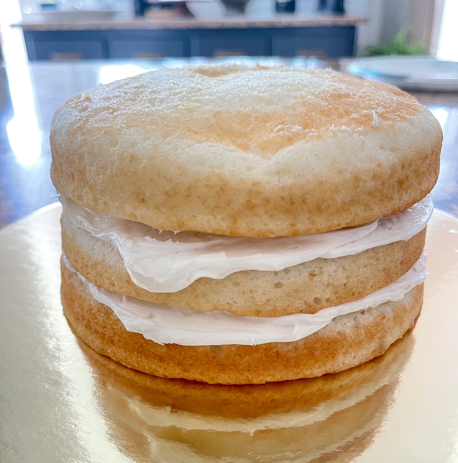 layered cake with white frosting in between layers