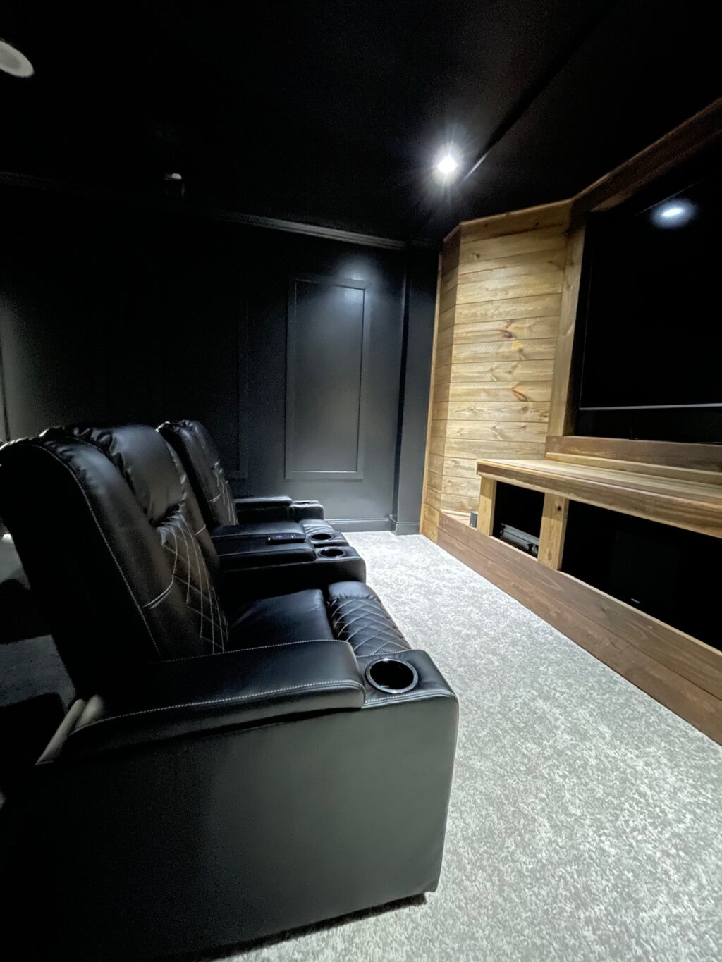 media room with black recliners