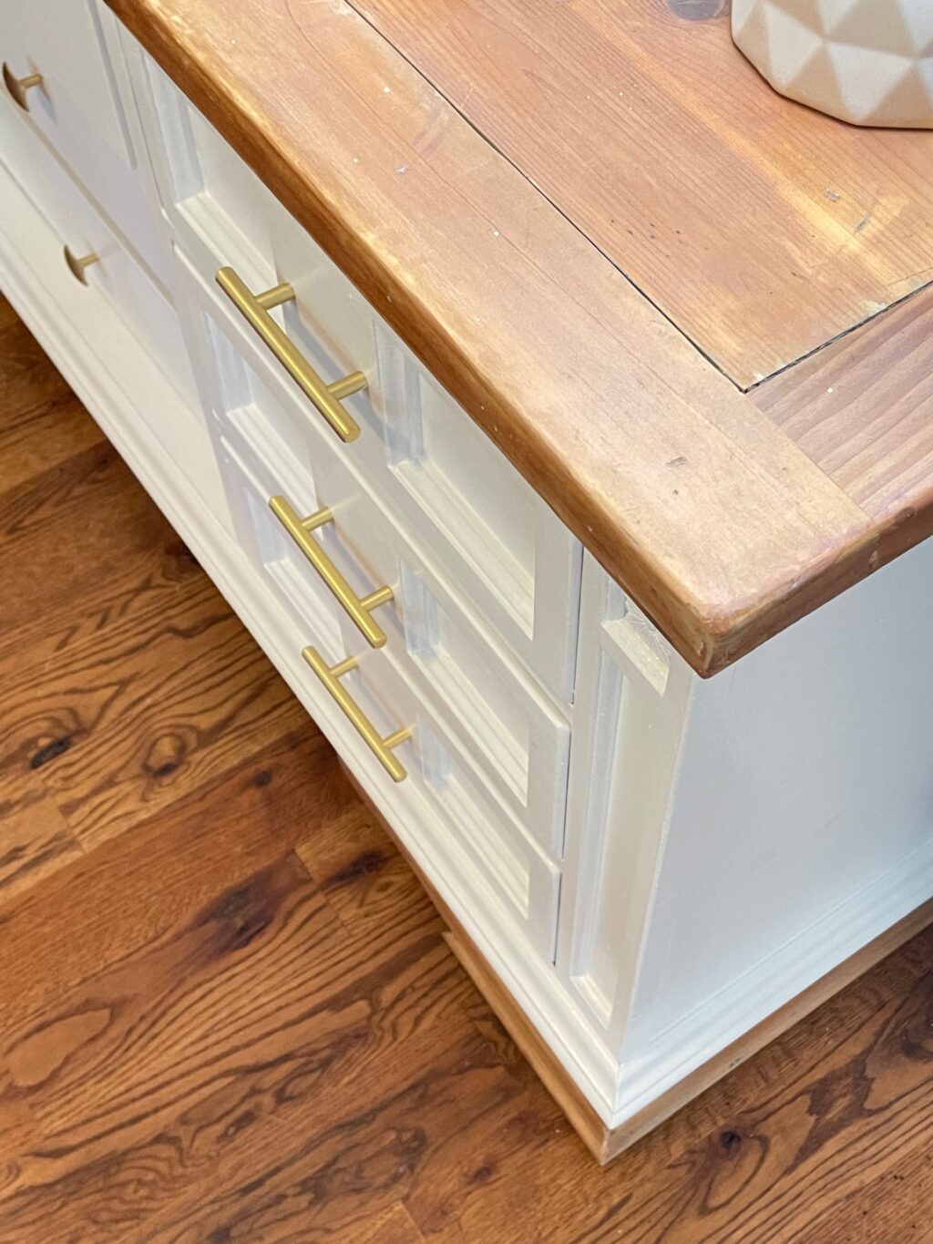 exposed wood top and white body dresser with brass handles