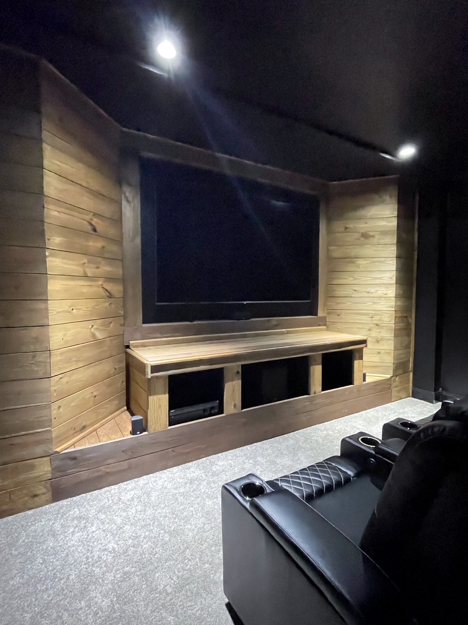 modern media room with wood wall and tv