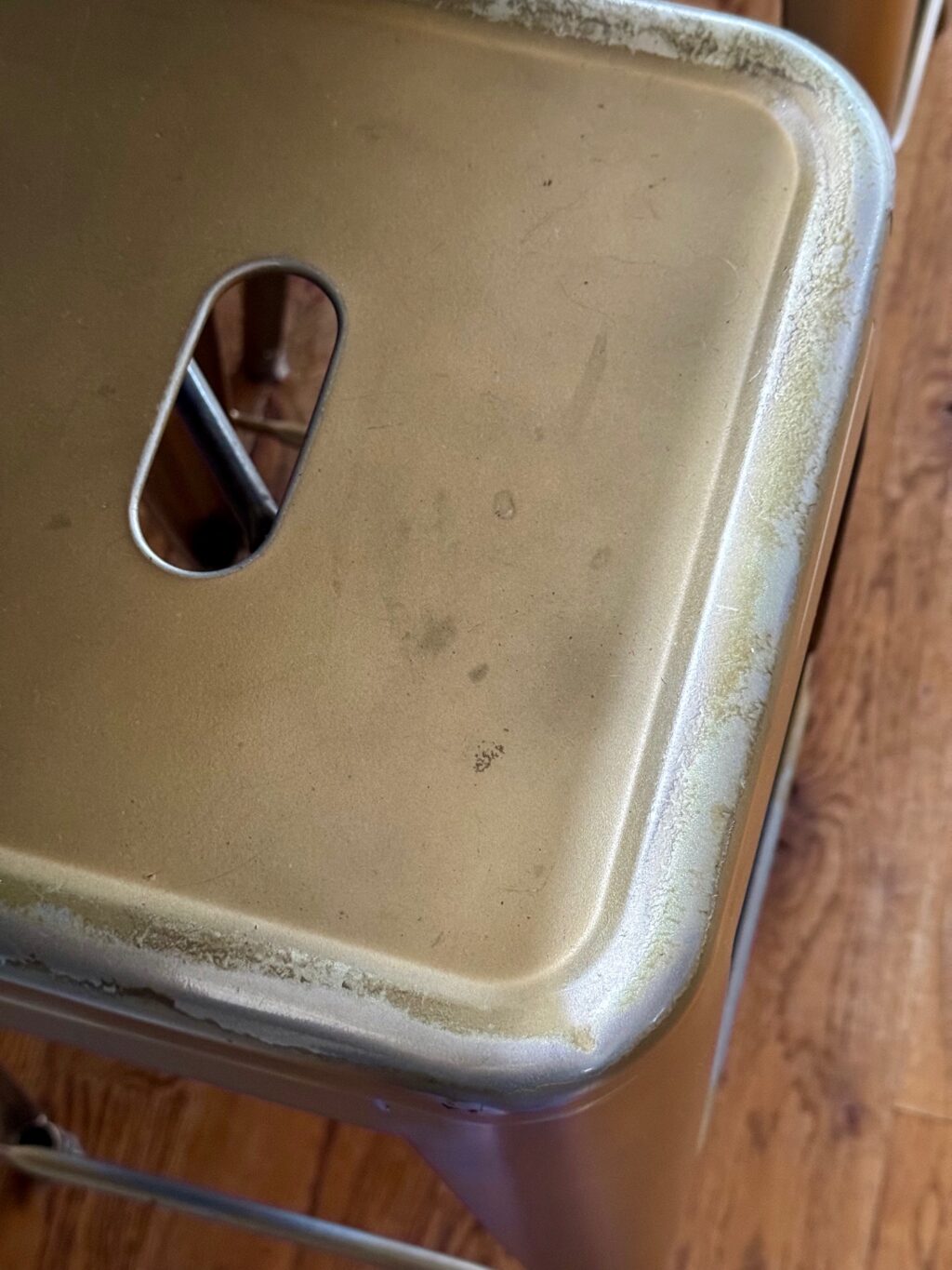 close up of barn stool with fading paint