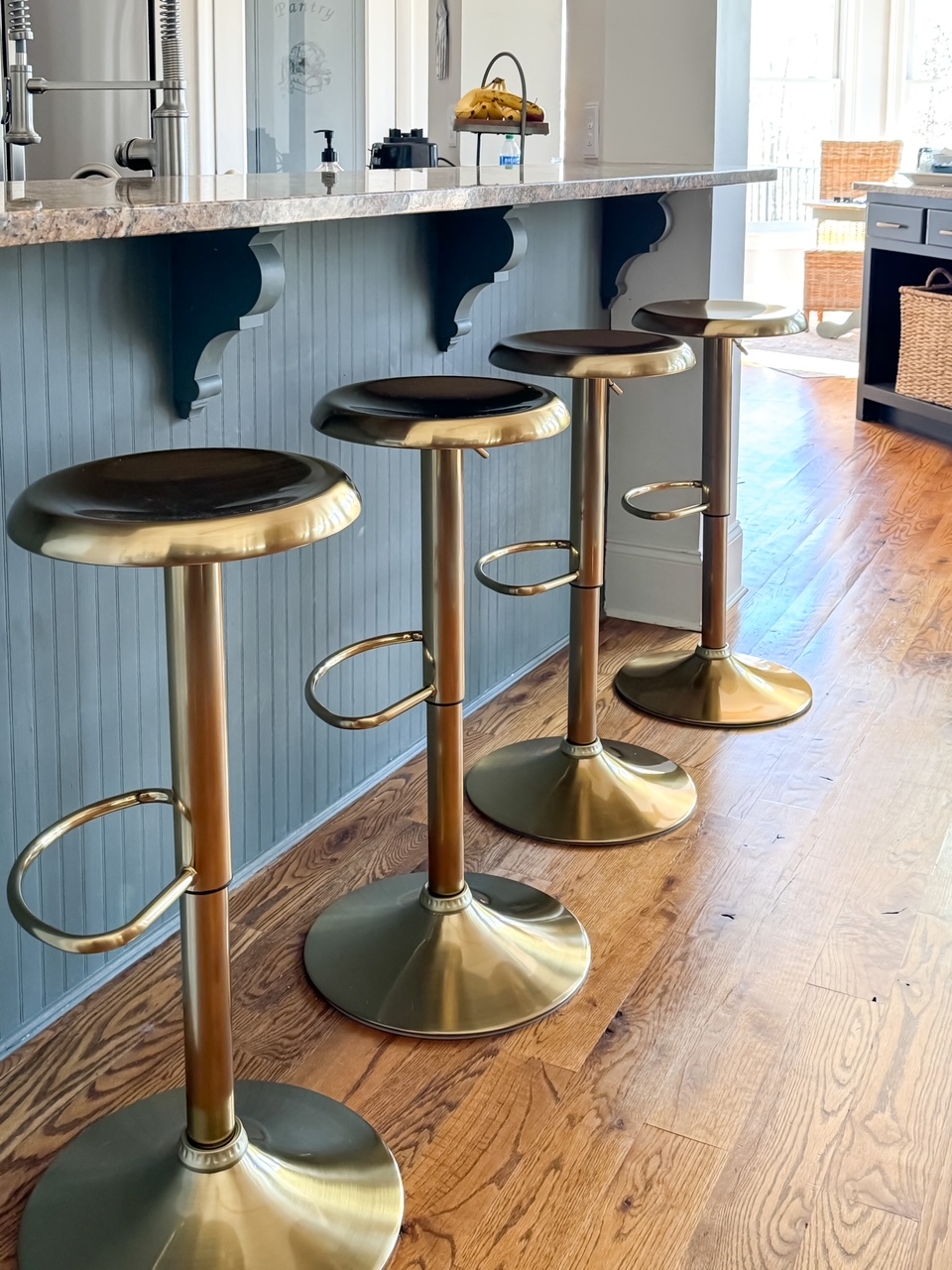 kitchen island with brass bar stools