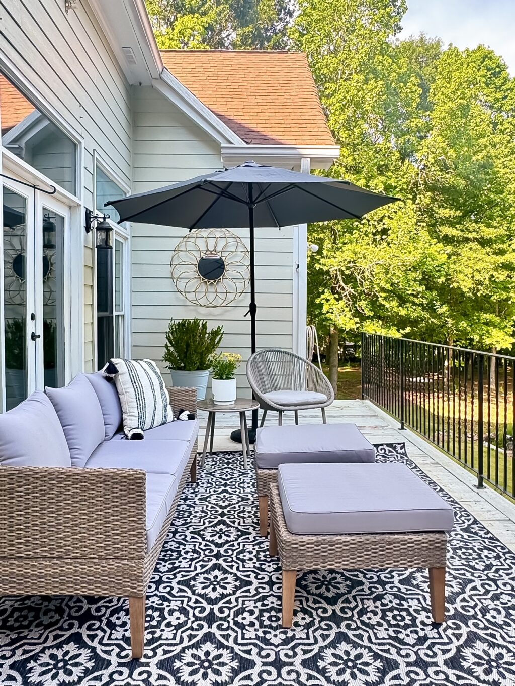 patio with sectional and gray and black rug