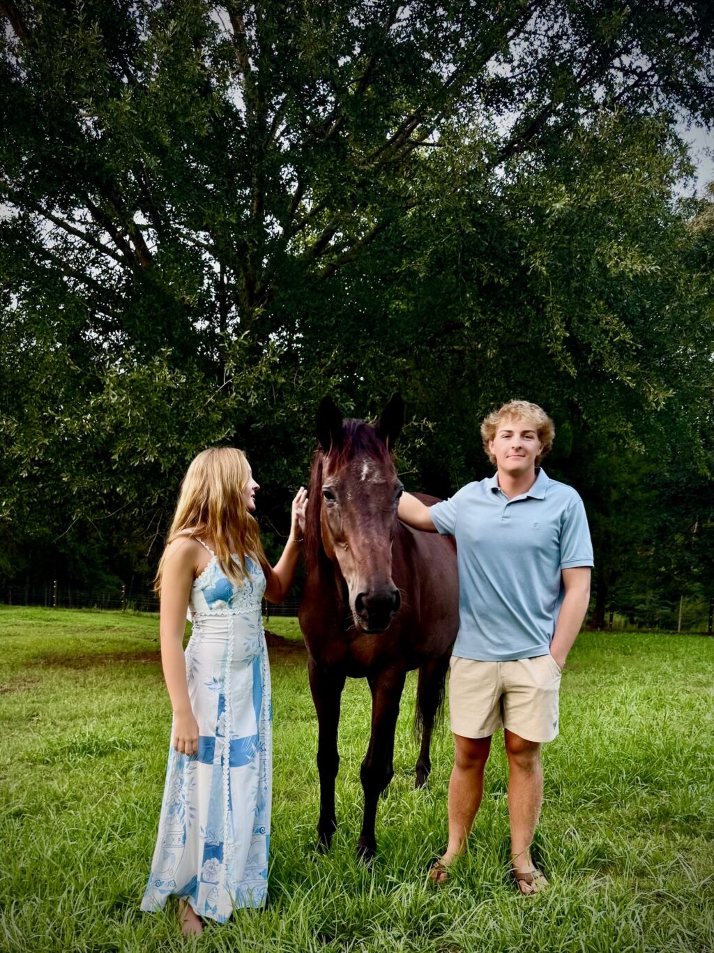 two kids with horse in a pasture and weekend hangout at duke manor Farm