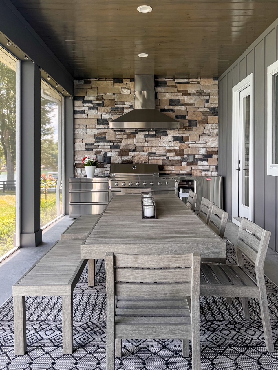 wooden dining table with outdoor kitchen